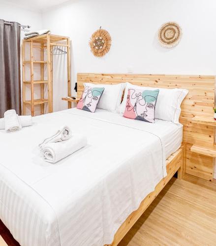 a bedroom with a large white bed with pillows at Village View Apartments in Himare