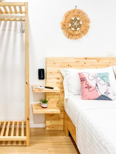 a bedroom with a bed with a wooden headboard at Village View Apartments in Himare
