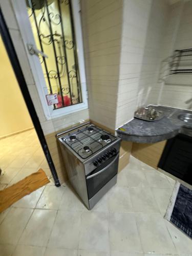 a stove in the corner of a kitchen with a window at Downtown Fez Delight Apartment in Fez