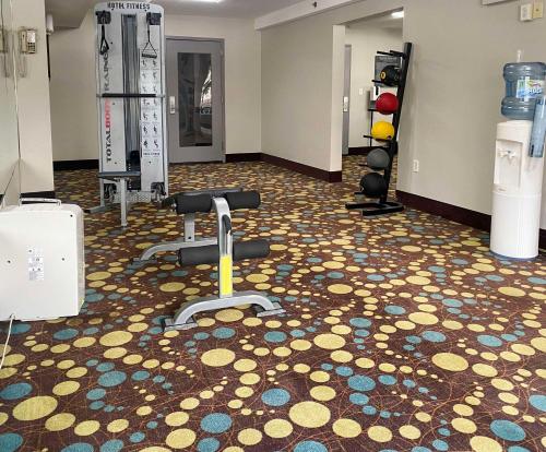 a room with a gym with dumbbells on the floor at MainStay Suites Conover-Hickory in Conover