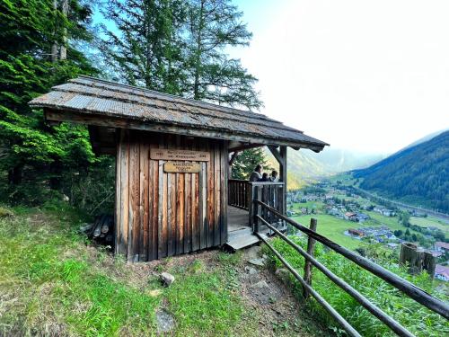 a small wooden building on the side of a hill at AH Carinthia Mallnitz - Carinthia Appartements in Mallnitz