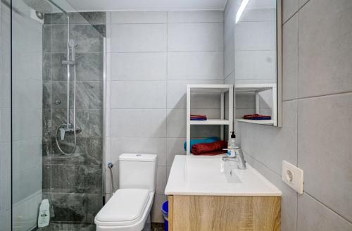 a bathroom with a toilet and a sink and a shower at Buena Vista in Los Cristianos