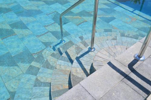 a shadow of a railing on the floor of a pool at Av Club Terme Colella in Ischia