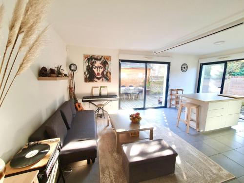 a living room with a couch and a table at Maison de famille à 300m de la plage in Labenne