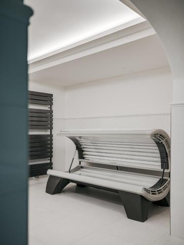 a empty bench in a room with a ceiling at Vila Zlatý Slavík - Luxurious Villa with Spa in Jevany