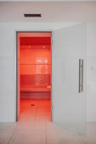 an open door to a room with red walls at Vila Zlatý Slavík - Luxurious Villa with Spa in Jevany