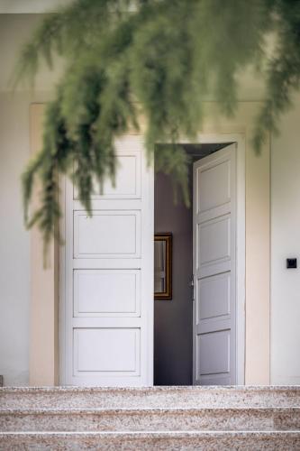 a white door in front of a house at Vila Zlatý Slavík - Luxurious Villa with Spa in Jevany