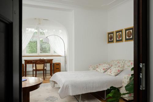 a living room with a couch and a table at Vila Zlatý Slavík - Luxurious Villa with Spa in Jevany