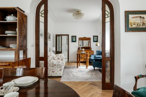 a living room with a table and a chair at Vila Zlatý Slavík - Luxurious Villa with Spa in Jevany