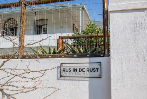 a sign that readsubs in de rust in front of a building at Rus In De Rust in De Rust