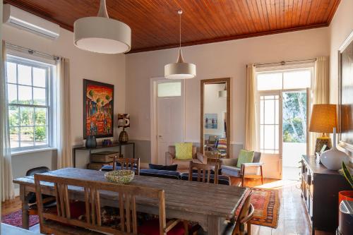 a living room with a wooden table and chairs at Rus In De Rust in De Rust