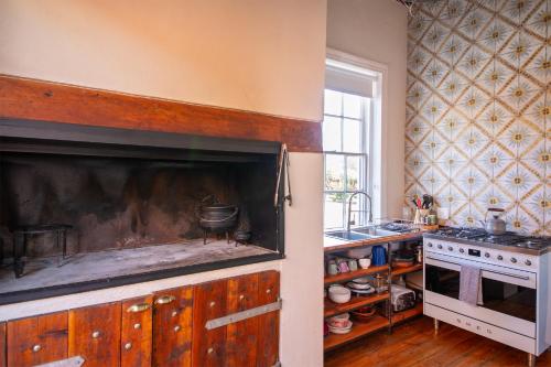 a kitchen with a stove and a sink at Rus In De Rust in De Rust