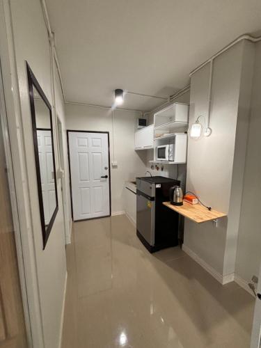 a small kitchen with a counter and a refrigerator at Private room hosted by Boyce 415 in Chiang Mai