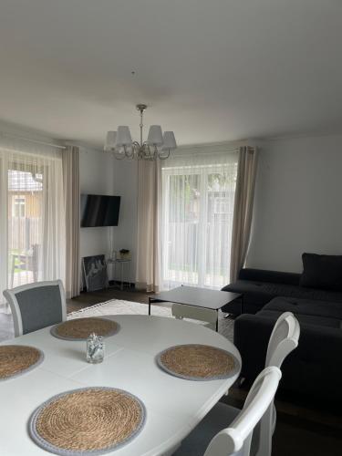 a living room with a white table and chairs at Private Trakai Historical Centre Karaim Two Floor Apartment in Trakai