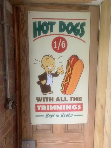 a hot dogs with all the trimmings sign on a door at City Centre Stylish Hideaway in Exeter