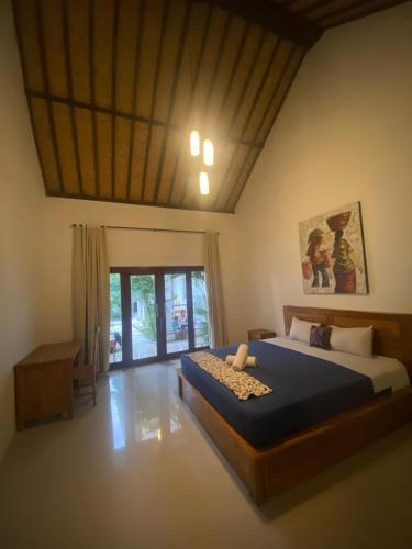 a bedroom with a large bed in a room at Adore guesthouse in Amed