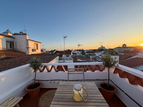 a table on a balcony with a view of a city at Private Alentejo house with a terrace in Évora