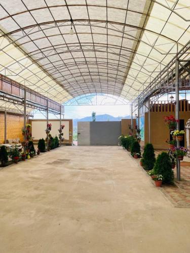 a large building with a lot of plants in it at Guest house Amirhan in Bokonbayevo