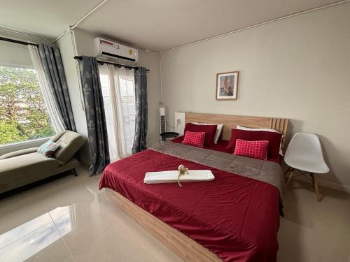 a bedroom with a large bed with a red blanket at Private room hosted by Boyce 415 in Chiang Mai