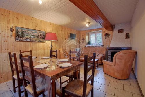 a dining room with a table and a living room at 113 Val d'Azun - Gîte 6 voyageurs in Arrens-Marsous