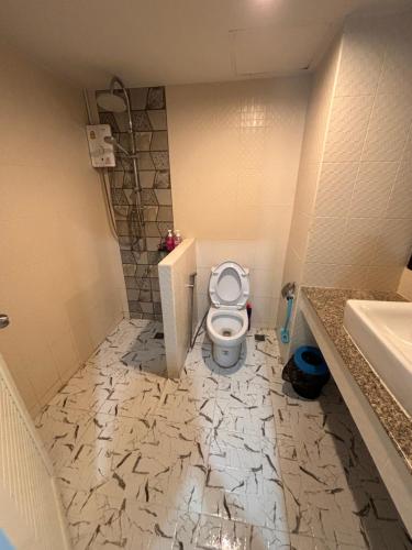 a bathroom with a toilet and a sink at Private room hosted by Boyce 415 in Chiang Mai