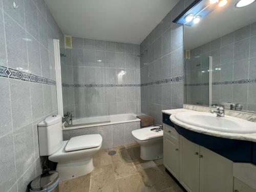 a bathroom with a sink and a toilet and a sink at Puerto Marina in Benalmádena