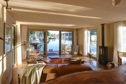a living room with a couch and a large window at Hausboot vom Feinsten in Berlin