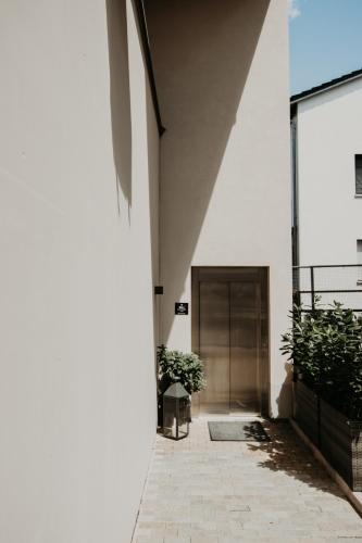 a hallway of a building with a table and plants at Jill Apartments in Rust
