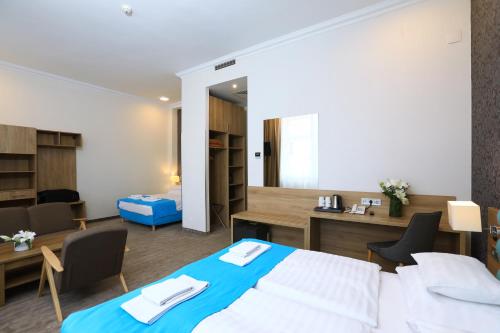 a hotel room with a bed and a desk at Medos Hotel in Budapest
