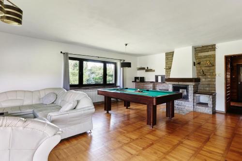 a living room with a ping pong table at Dom Kubicowka in Rybarzowice