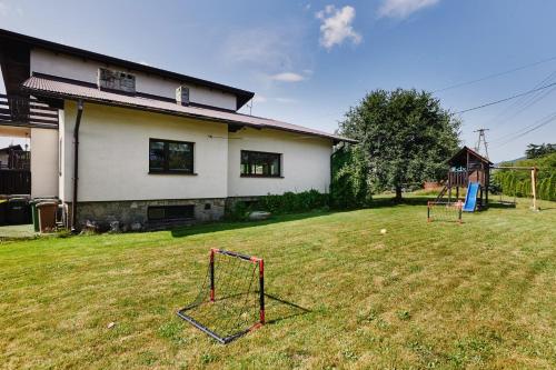 a yard with two nets in front of a house at Dom Kubicowka in Rybarzowice