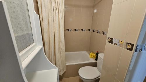a bathroom with a toilet and a tub and a sink at Apartamento Cuevas de Mar in Cuevas