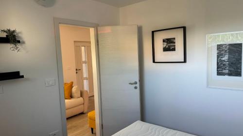 a door leading to a living room with a couch at Apartment Malija Cikloped in Izola