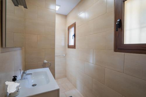 a bathroom with a sink and a mirror at Casa Horizonte in Moraira