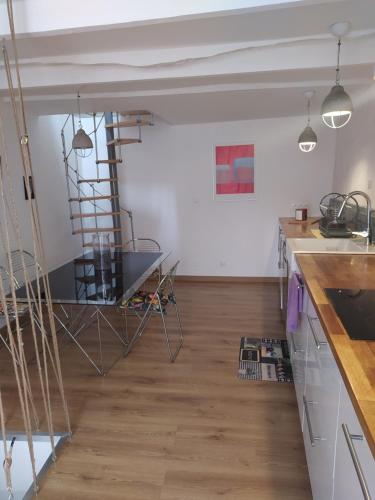 a kitchen with a wooden floor and a ladder at La maison du pêcheur in Bouzigues