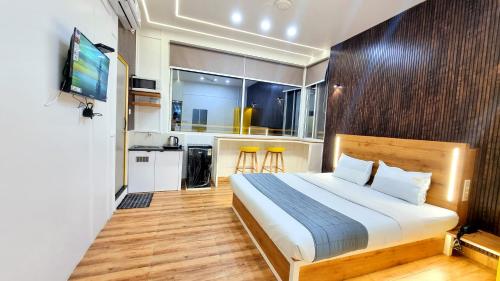 a small bedroom with a bed and a kitchen at Stayinn Nest in Bhopal