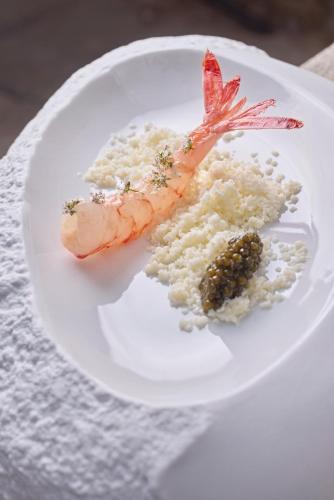a plate of food with a shrimp and rice at Mirador de Dalt Vila-Relais & Chateaux in Ibiza Town