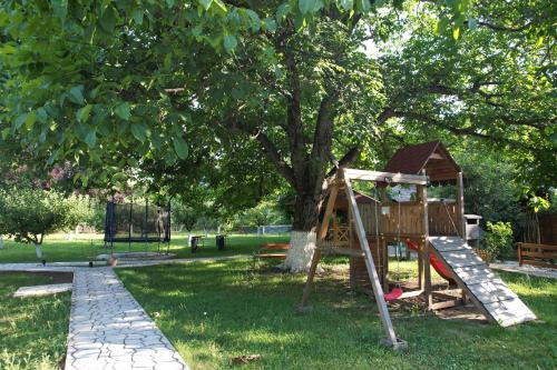 a playground in a park with a tree at Casa Stefandra in Breaza