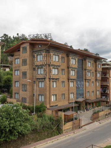 a large brick building on the side of a street at Hotel Samye - Best Hotel In Thimphu in Thimphu