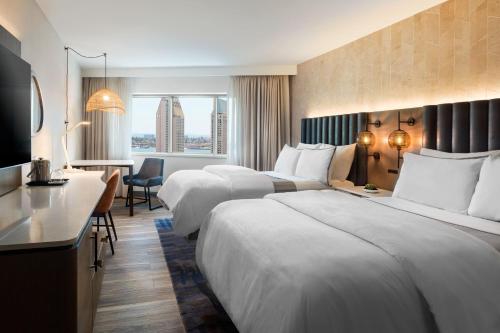 a hotel room with two beds and a desk at The Westin San Diego Bayview in San Diego