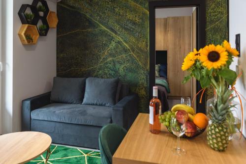 a living room with a table with a blue couch at Rio - Apartament Plaza Tower - Targi Kielce - Faktura VAT- INVOICE - Air Condition in Kielce