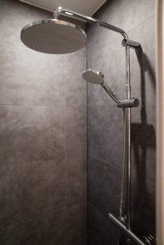 une douche avec pommeau de douche dans une salle de bain dans l'établissement Gite 