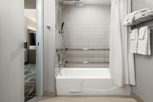 a bathroom with a shower and a bath tub at The Westin San Diego Bayview in San Diego