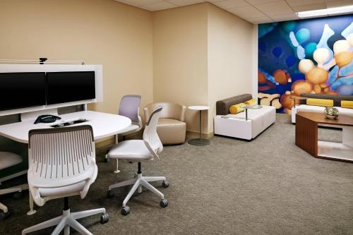 an office with a table and chairs and a tv at The Westin San Diego Bayview in San Diego