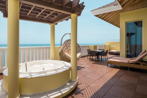 a hot tub on the balcony of a resort at JOIA Rose Hall by Iberostar - Adults Only All Inclusive Resort in Montego Bay
