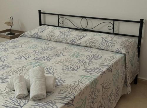 a bed with two towels on top of it at Appartamento in Centro in Lampedusa