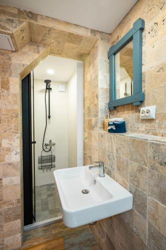 a bathroom with a sink and a shower at Terra Apart in Sinemorets
