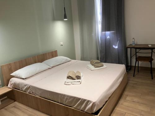 a bedroom with a bed with two towels on it at bayekou trapani in Trapani