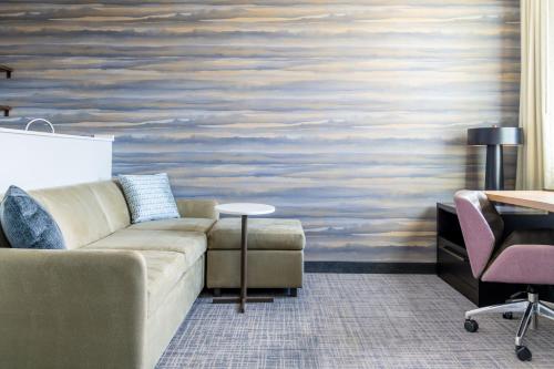 a living room with a couch and a table at Residence Inn by Marriott Arvada Denver West in Arvada