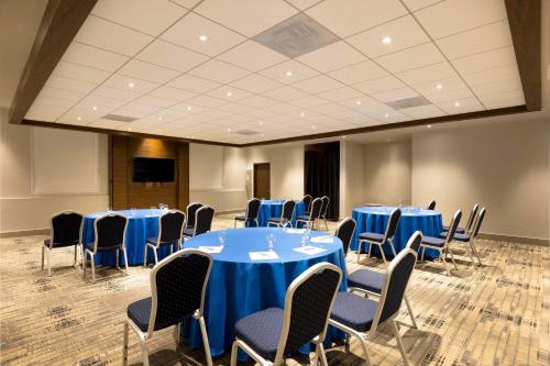 a conference room with blue tables and chairs at Four Points by Sheraton Caguas Real in Caguas